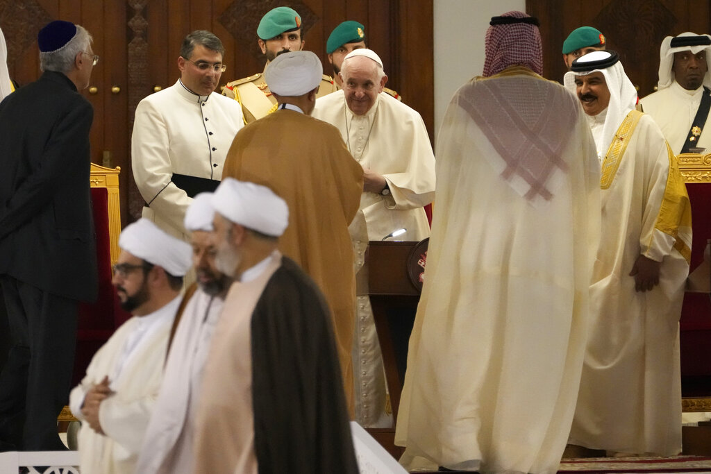 Pope Francis, center, speaks with a Muslim Shiite Sheik, as Bahrain's King Hamad bin Isa Al Khalifa stands on the right, at the Sakhir Royal Palace, Bahrain, Thursday, Nov. 3, 2022. Pope Francis is making the November 3-6 visit to participate in a government-sponsored conference on East-West dialogue and to minister to Bahrain's tiny Catholic community, part of his effort to pursue dialogue with the Muslim world. (AP Photo/Hussein Malla)