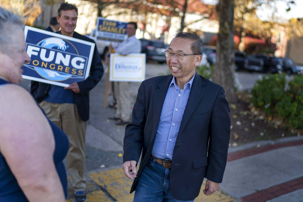 Former Cranston, R.I., Mayor and Republican candidate for the state's 2nd Congressional District, Allan Fung, greets voters outside a polling site in Warwick, R.I., Monday, Nov. 7, 2022, on the last day of early voting before the midterm election. (AP Photo/David Goldman)