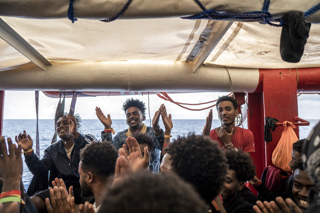 Migrants react on board the humanitarian ship Ocean Viking heading to France with 230 migrants saved from the Mediterranean Sea, Thursday, Nov. 10, 2022. France will let the migrants disembark in Toloun. (AP Photo/Vincenzo Circosta)