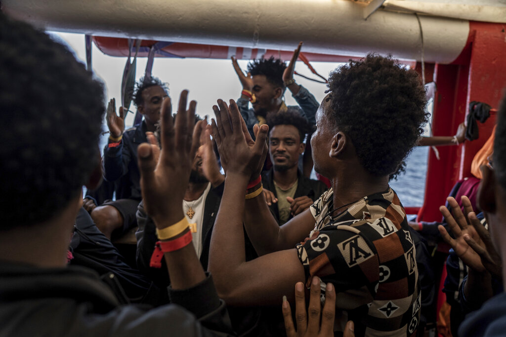 Migrants react on board the humanitarian ship Ocean Viking heading to France with 230 migrants saved from the Mediterranean Sea, Thursday, Nov. 10, 2022. France will let the migrants disembark in Toloun. (AP Photo/Vincenzo Circosta)