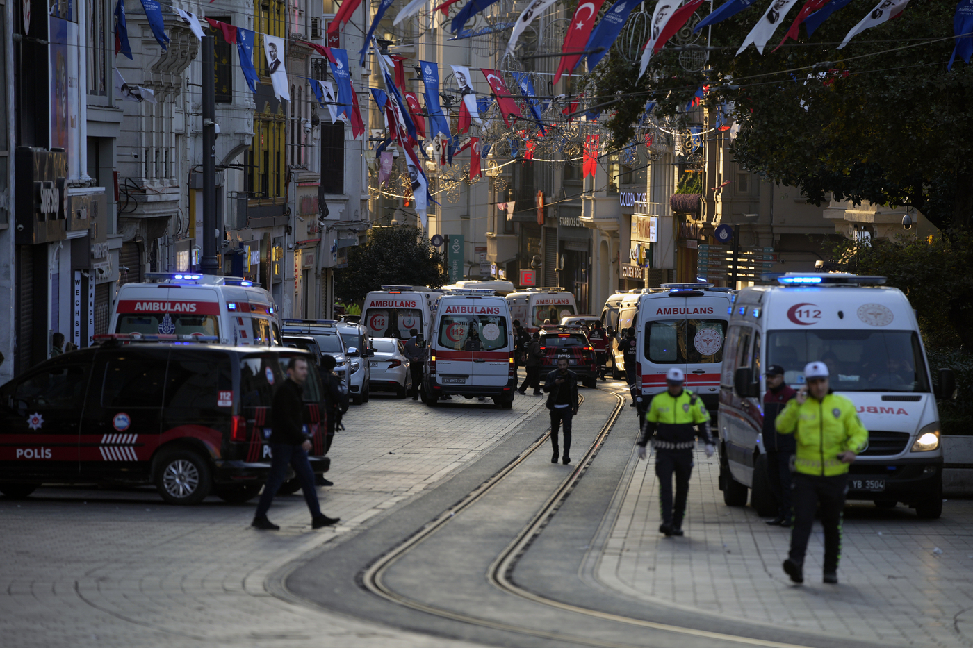 Police vehicles and ambulances are parked at the site of an explosion on Istanbul's popular pedestrian Istiklal Avenue in Istanbul, Turkey, Sunday, Nov. 13, 2022. Istanbul Gov. Ali Yerlikaya tweeted that the explosion occurred at about 4:20 p.m. (1320 GMT) and that there were deaths and injuries, but he did not say how many. The cause of the explosion was not clear. (AP Photo/Francisco Seco)