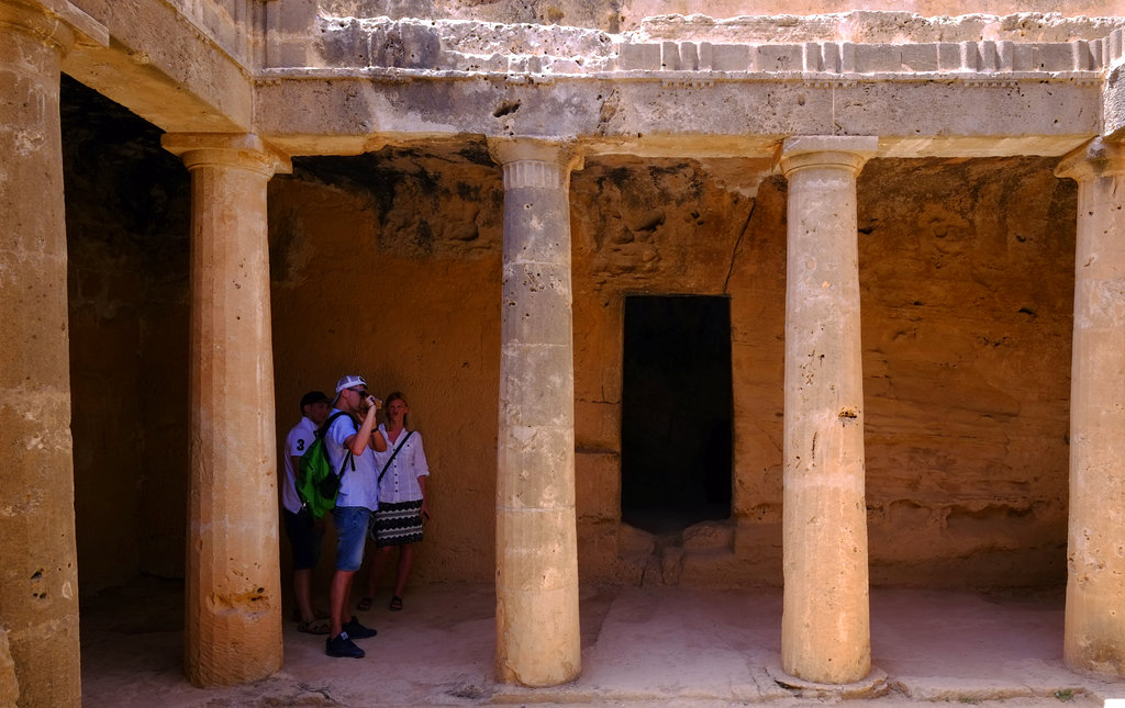 Tourist takes photos at the 'Tombs of the Kings' that built during the Hellenistic period (3rd century B.C.) in southwest coastal city of Paphos in the eastern Mediterranean island of Cyprus, Monday, May 1, 2017. The 'Tombs of the Kings' is the impressive necropolis that is located just outside the walls, to the north and east of Pafos city. (AP Photo/Petros Karadjias)