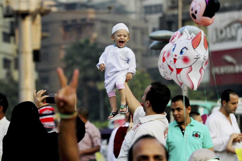 FILE - In this Saturday, Oct. 4, 2014 file photo, Egyptians celebrate after the early morning prayers marking Eid al-Adha, in Cairo, Egypt. Egypts fertility rate, which has been falling since at least 1980, has risen dramatically in the last six years, said survey results released to The Associated Press, Monday, Oct. 27, 2014. The survey, conducted jointly with Egypts Ministry of Health and Population and a U.S. Agency for International Development-funded organization, said the number of births per woman has increased from 3 to 3.5 since 2008. The news raises serious economic concerns for the Arab worlds most populous country, whose economy has been staggering since its 2011 revolt. (AP Photo/Hussein Tallal, File)