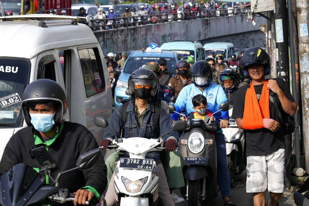 Motorists are stuck in the morning rush hour traffic in Jakarta, Indonesia, Monday, Nov. 14, 2022. The world's population is projected to hit an estimated 8 billion people on Tuesday, Nov. 15, according to a United Nations projection. (AP Photo/Tatan Syuflana)