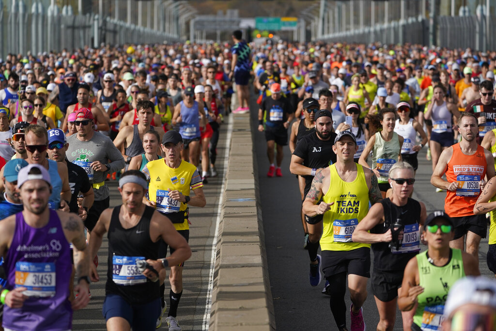 Runners cross the Verrazzano-Narrows Bridge at the start of the New York City Marathon in New York, Sunday, Nov. 6, 2022. The world's population is projected to hit an estimated 8 billion people on Tuesday, Nov. 15, according to a United Nations projection. (AP Photo/Seth Wenig)