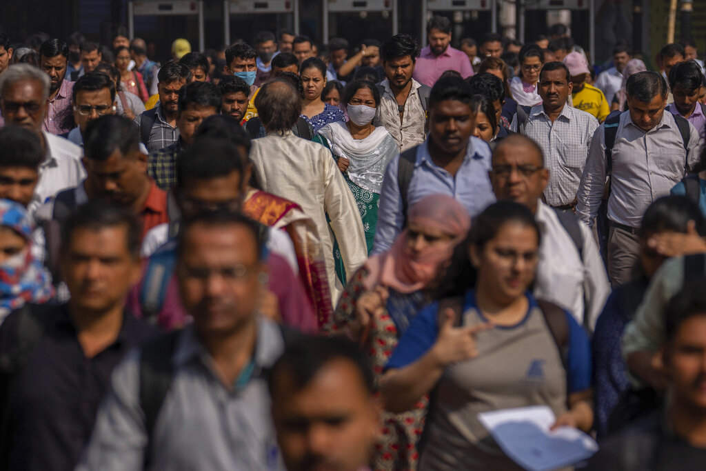 Indian commuters leave at Chhatrapati Shivaji Maharaj train terminus in Mumbai, India, Monday, Nov. 14, 2022. The world's population is projected to hit an estimated 8 billion people on Tuesday, Nov. 15, according to a United Nations projection. (AP Photo/Rafiq Maqbool)