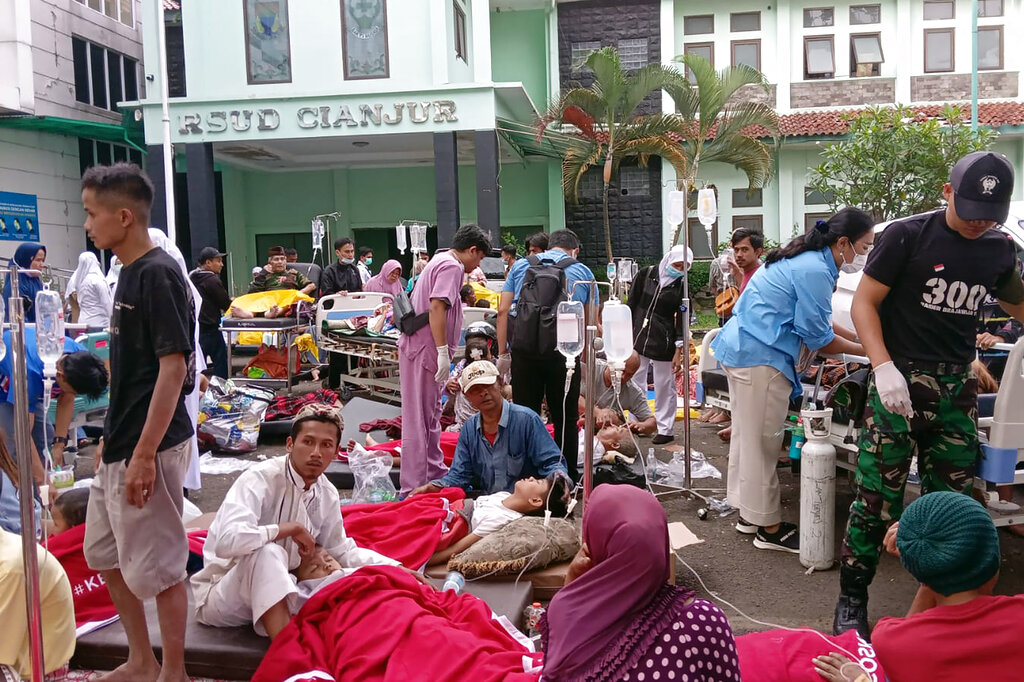 Survivors receive medical treatment outside of a local hospital following an earthquake in Cianjur, West Java, Indonesia, Monday, Nov. 21, 2022. An earthquake shook Indonesia’s main island of Java on Monday, killing a number of people, damaging dozens of buildings and sending residents into the capital's streets for safety. (AP Photo/Firman Taqur)