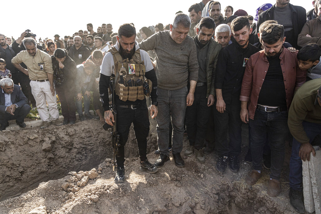 Syrian Kurds attend a funeral of people killed in Turkish airstrikes in the village of Al Malikiyah , northern Syria, Monday, Nov. 21, 2022. The airstrikes, which Turkey said were aimed at Kurdish militants whom Ankara blamed for a deadly Nov. 13 bombing in Istanbul, also struck several Syrian army positions in three different provinces along the border with Turkey. (AP Photo/Baderkhan Ahmad)
