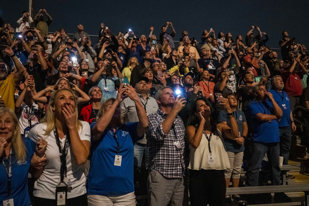 In this photo provided by NASA, guests at the Banana Creek watch the launch of NASA's Space Launch System rocket carrying the Orion spacecraft on the Artemis I flight test, early Wednesday, Nov. 16, 2022, at NASA's Kennedy Space Center in Fla. (Keegan Barber/NASA via AP)