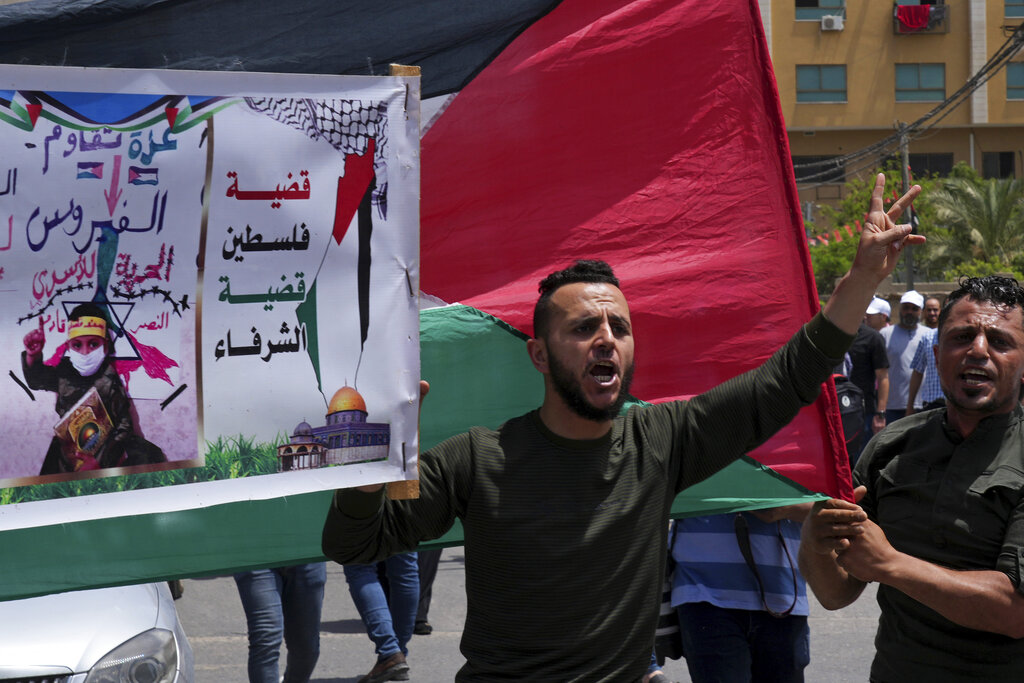 Palestinians attend a rally marking the 74h anniversary of what the Palestinians call the 