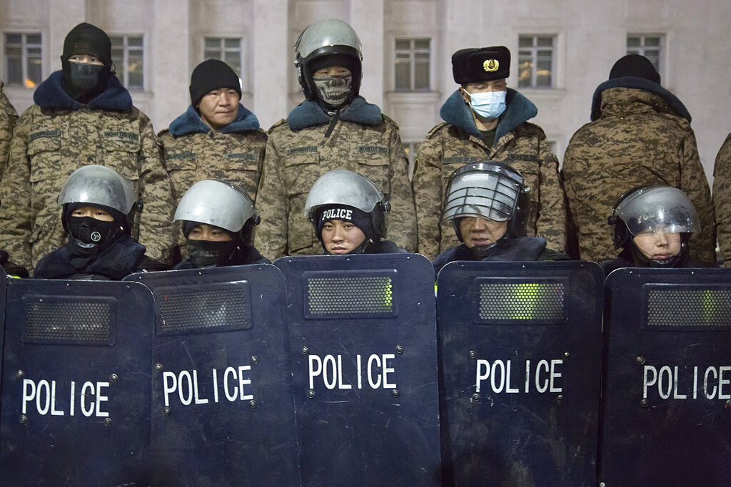 Police form up behind shields during a protest on Sukhbaatar Square in Ulaanbaatar in Mongolia on Monday, Dec. 5, 2022. Protesters angered by allegations of corruption linked to Mongolia's coal trade with China have stormed the State Palace in the capital, demanding dismissals of officials involved in the scandal. (AP Photo/Alexander Nikolskiy)