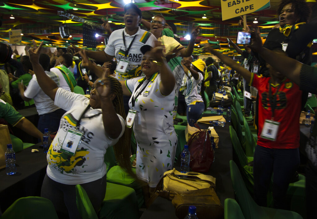 African National Congress delegates cheer as they wait for the delayed start of the ANC national conference in Johannesburg, South Africa, Friday Dec. 16, 2022. The conference will elect the party's leadership and adopt key policies for governing the country. President Cyril Ramaphosa is seeking re-election as the party's leader at the national conference which is held every five years and is the ANC's highest decision-making body. (AP Photo/Denis Farrell)