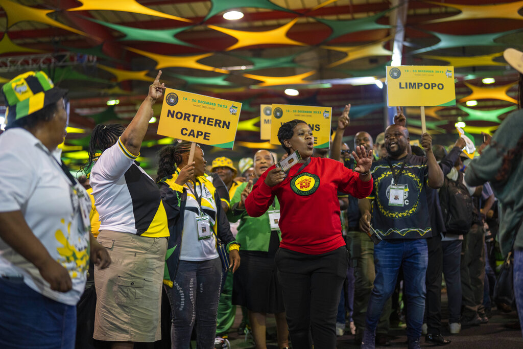 African National Congress delegates cheer as they wait for the delayed start of the ANC national conference in Johannesburg, South Africa, Friday Dec. 16, 2022. The conference will elect the party's leadership and adopt key policies for governing the country. President Cyril Ramaphosa is seeking re-election as the party's leader at the national conference which is held every five years and is the ANC's highest decision-making body. (AP Photo/Jerome Delay)