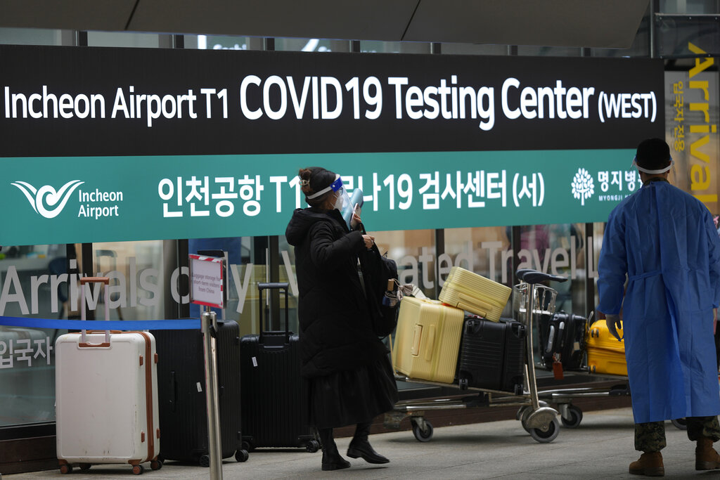 A woman arriving from China enters a COVID-19 testing center at the Incheon International Airport In Incheon, South Korea, Thursday, Jan. 5, 2023. (AP Photo/Lee Jin-man)