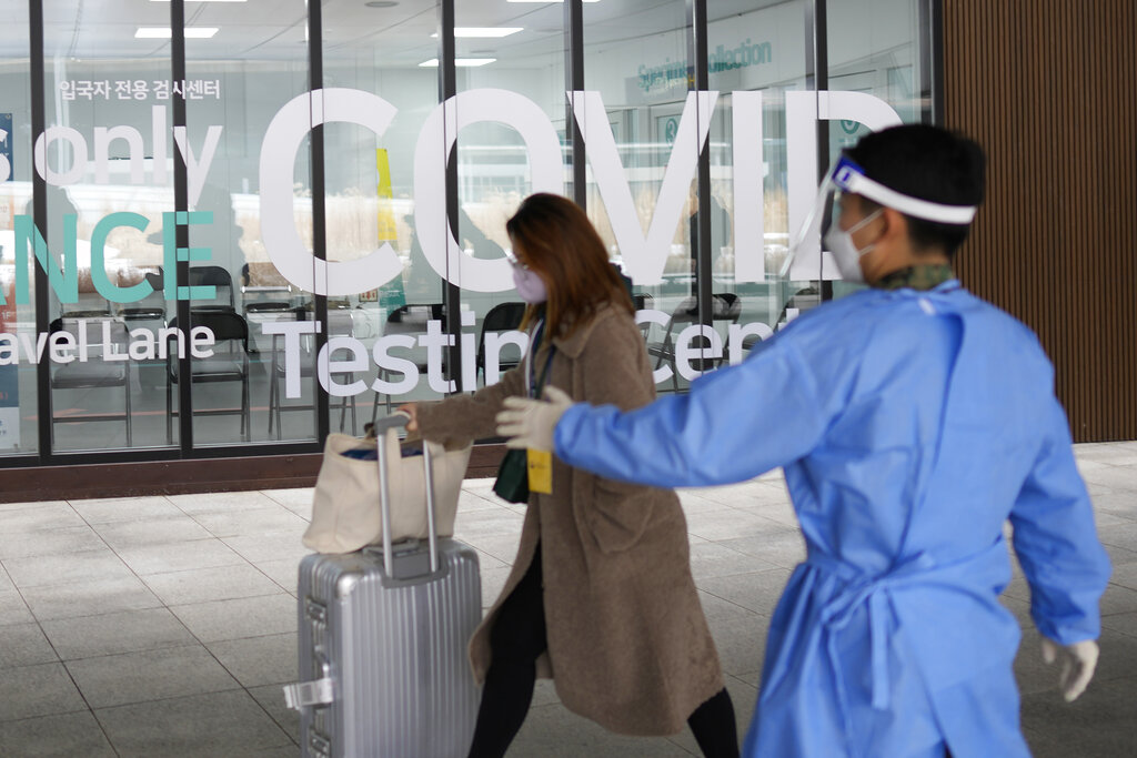 A woman arriving from China enters a COVID-19 testing center at the Incheon International Airport In Incheon, South Korea, Thursday, Jan. 5, 2023. (AP Photo/Lee Jin-man)