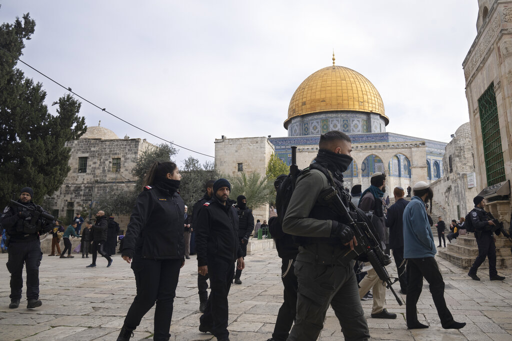 Israeli police escort Jewish visitors to the Al-Aqsa Mosque compound, known to Muslims as the Noble Sanctuary and to Jews as the Temple Mount, in the Old City of Jerusalem, Tuesday, Jan. 3, 2023. Itamar Ben-Gvir, an ultranationalist Israeli Cabinet minister, visited the flashpoint Jerusalem holy site Tuesday for the first time since taking office in Prime Minister Benjamin Netanyahu's new far-right government last week. The visit is seen by Palestinians as a provocation. (AP Photo/Maya Alleruzzo)