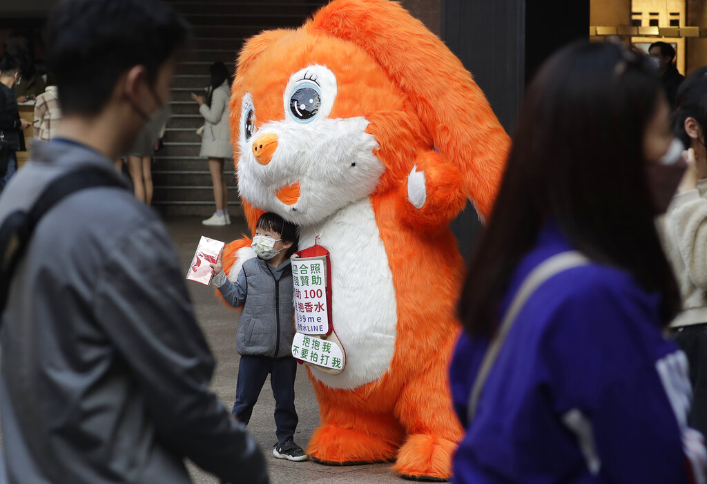 A boy takes a photo with a rabbit doll during an activity for the upcoming Chinese Lunar New Year, the year of the Rabbit according to the Chinese zodiac, in Taipei, Taiwan, Thursday, Jan. 19, 2023. The new year celebrations will take place on Jan. 22. (AP Photo/Chiang Ying-ying)