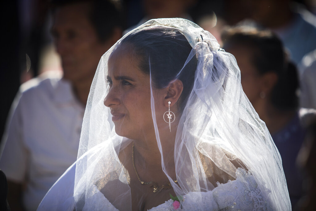 A bride participates in a mass wedding in Managua, Nicaragua, Tuesday, Feb 14, 2023. (AP Photo/Inti Ocon)