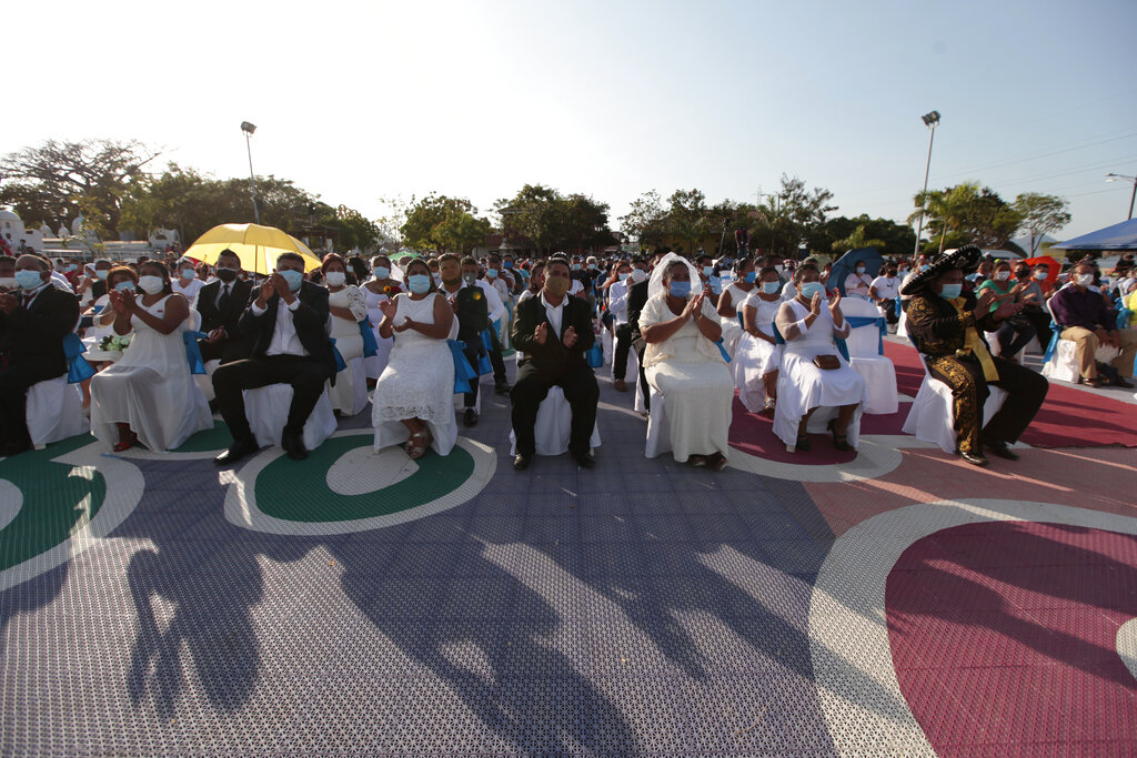 Couples sit together during a mass wedding in Managua, Nicaragua, Sunday, Feb 14, 2021. Around 400 couples said 
