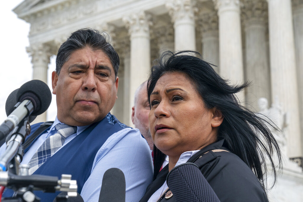 Beatriz Gonzalez, right, the mother of 23-year-old Nohemi Gonzalez, a student killed in the Paris terrorist attacks, and stepfather Jose Hernandez, speak outside the Supreme Court,Tuesday, Feb. 21, 2023, in Washington. A lawsuit against YouTube from the family of Nohemi Gonzalez was argued at the Supreme Court. (AP Photo/Alex Brandon)