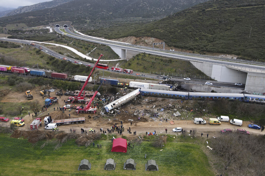Debris of trains lie on the rail lines after a collision in Tempe, about 376 kilometres (235 miles) north of Athens, near Larissa city, Greece, Wednesday, March 1, 2023. A passenger train carrying hundreds of people, including many university students returning home from holiday, collided at high speed before midnight Tuesday with an oncoming freight train. (AP Photo/Giannis Papanikos)