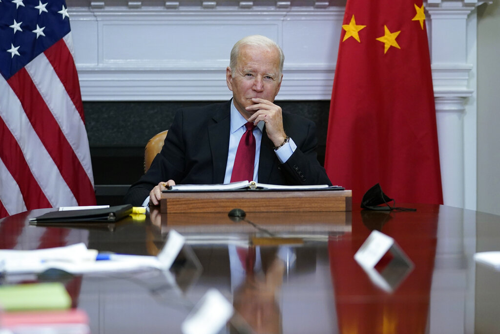 FILE - President Joe Biden listens as he meets virtually with Chinese President Xi Jinping from the Roosevelt Room of the White House in Washington, Monday, Nov. 15, 2021. China has long been seen by the U.S. as a prolific source of anti-American propaganda but less aggressive in its influence operations than Russia. But many in Washington now think China is increasingly following Russia’s lead — and there’s growing concern the U.S. isn’t doing enough to respond. (AP Photo/Susan Walsh, File)