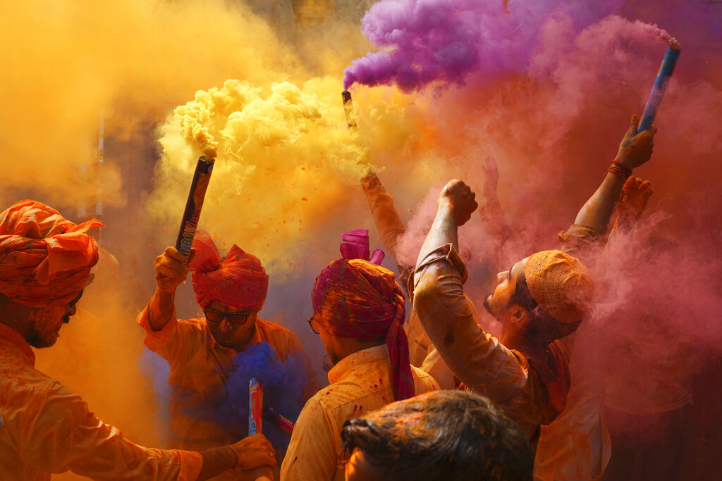 People sing, dance and throw colors at each other to celebrate Holi festival in Hyderabad, India, Monday, March 6, 2023. The festival will be observed on March 8, but the festivities starts almost a week in advance. It is celebrated across India to welcome good harvests, warm weather, and the defeat of evil. (AP Photo/Mahesh Kumar A.)