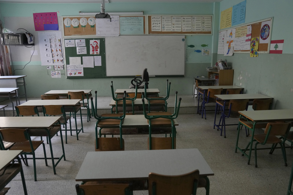 An empty classroom in a closed public school is seen in Beirut, Lebanon, Thursday, March 2, 2023. Public schools have been open for fewer than 50 days this school year because teachers are on strike, protesting dramatic currency devaluations that slashed their salaries to about $20 a month. (AP Photo/Hussein Malla)