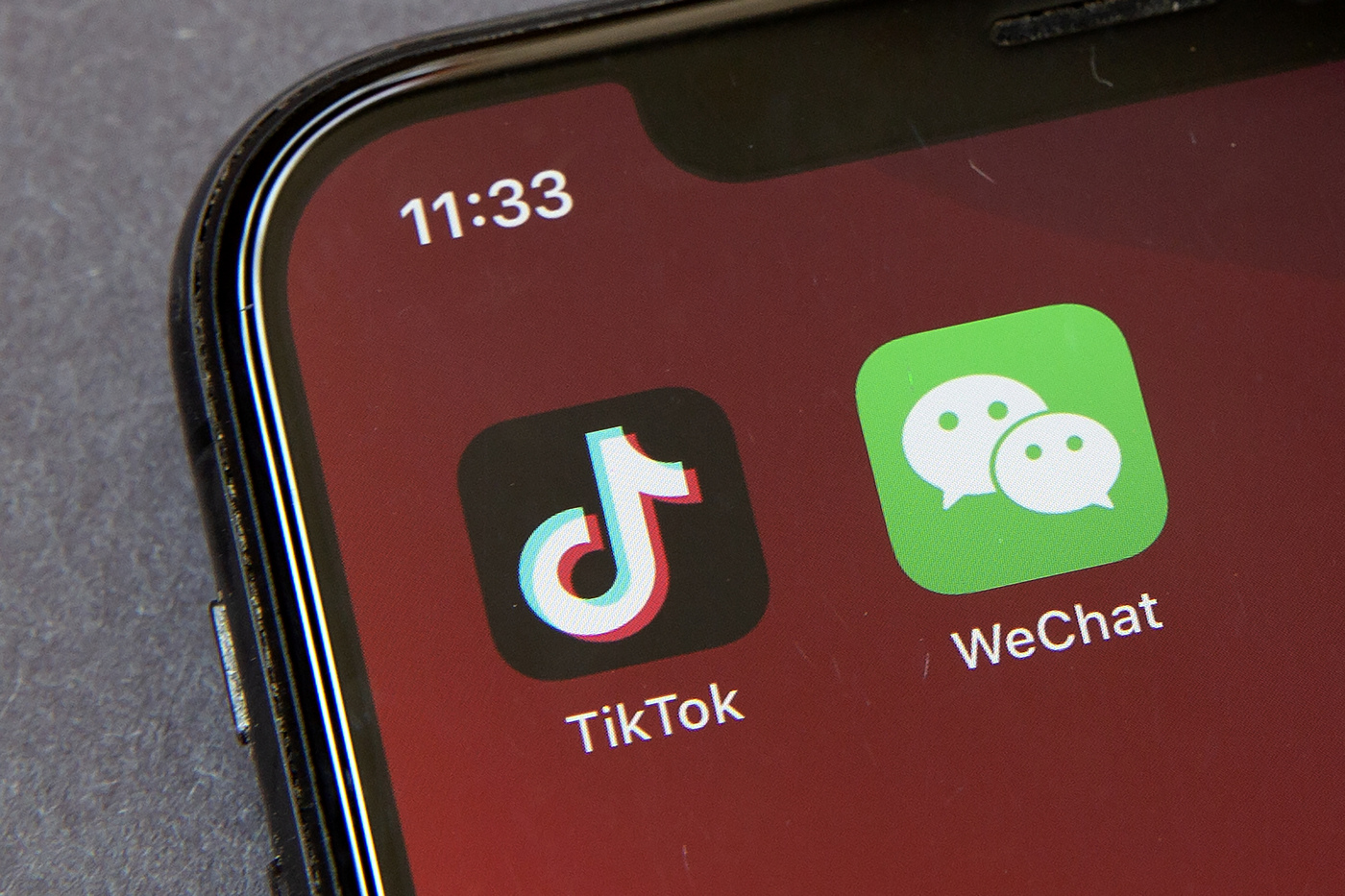 Icons for the smartphone apps TikTok and WeChat are seen on a smartphone screen in Beijing, Friday, Aug. 7, 2020. President Donald Trump has ordered a sweeping but unspecified ban on dealings with the Chinese owners of the consumer apps TikTok and WeChat, although it remains unclear if he has the legal authority to actually ban the apps from the U.S. (AP Photo/Mark Schiefelbein)
