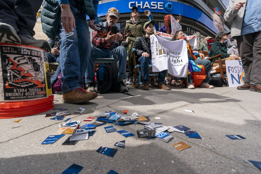 Activists put cut up credit cards in front of a Chase Bank during a 