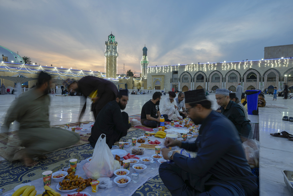 Muslims gather for a free public Iftar meal during the first day of Ramadan at sheikh Abdul qader Gilani mosque in Baghdad, Iraq, Thursday, March 23, 2023. Muslims throughout the world are marking the Ramadan -- a month of fasting during which observants abstain from food, drink and other pleasures from sunrise to sunset. (AP Photo/Hadi Mizban)