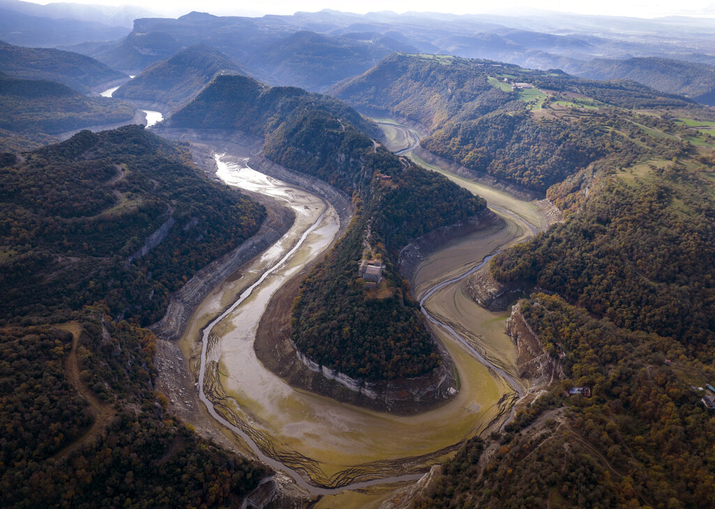 A view of the Ter river running dry toward a reservoir near Vilanova de Sau, Catalonia, Spain, Wednesday, Nov. 23, 2022. Restrictions on water use for agriculture and recreation purposes begin in Spain's Catalonia region, as a months-long drought that has devastated crops starts to put the pinch on human activities. (AP Photo/Emilio Morenatti)