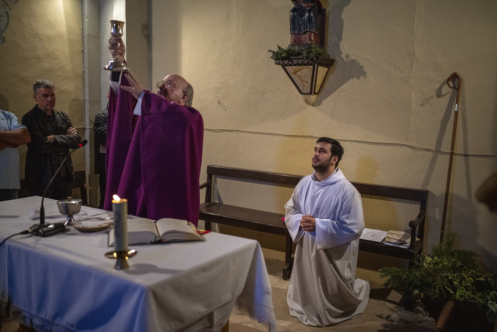 Local bishop Francesc Conesa leads a mass in the church of the Mare de Déu dels Torrents, in l'Espunyola, north of Barcelona, Spain, Sunday, March 26, 2023. Farmers and parishioners gathered Sunday at the small hermitage of l'Espunyola, a rural village in Catalonia, to attend a mass asking the local virgin Our Lady of the Torrents for rain. The eastern Spanish region is among the worst affected by the severe drought that hits the whole of the Mediterranean country. (AP Photo/Emilio Morenatti)