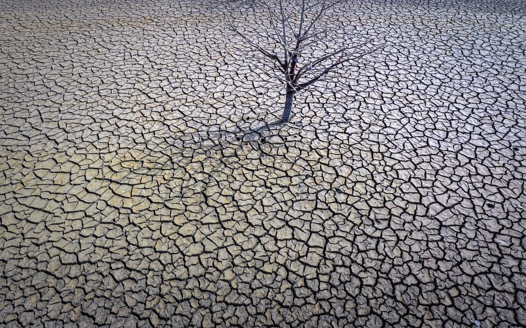 The cracked earth of the Sau reservoir is visible north of Barcelona, Spain, March 20, 2023. (AP Photo/Emilio Morenatti)