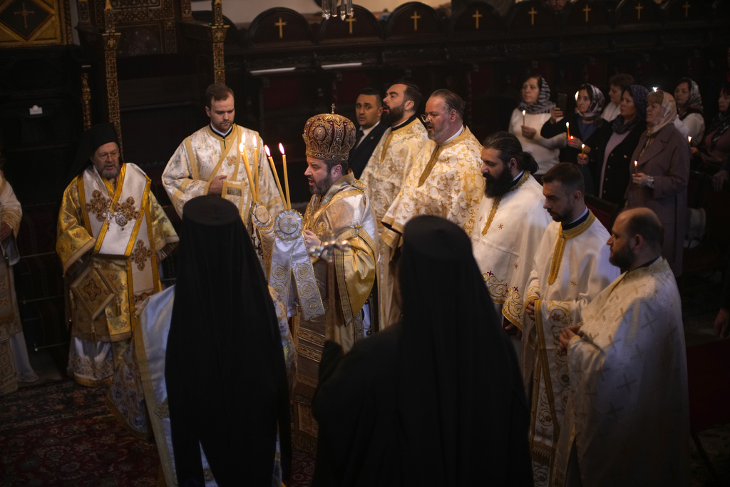 Orthodox Christian Metropolitan Maximos of Selyvria, center, leads a service during the Easter ceremony celebrating Christ's resurrection at the Patriarchal Church of St. George in Istanbul, Turkey, Sunday, April 16, 2023. About 300 million Orthodox Christians around the world celebrate on Sunday, April 16, the most important religious holiday in the Orthodox Christian calendar. (AP Photo/Francisco Seco)