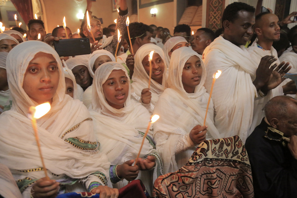 Ethiopian Orthodox Christians hold candles during the Easter religious procession in Addis Ababa, Sunday, April 16, 2023. (AP Photo) .