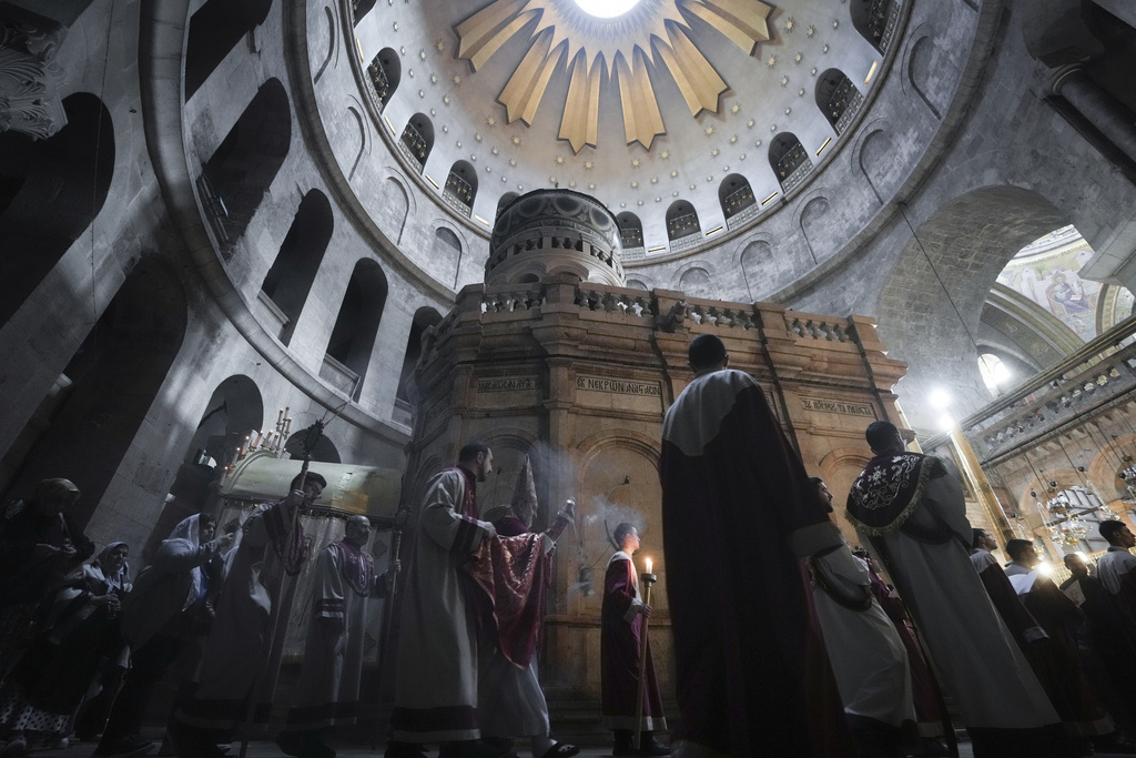Armenian Orthodox clergy attend an Easter procession, at the Church of the Holy Sepulcher, where many Christians believe Jesus was crucified, buried and resurrected, in Jerusalem's Old City, Sunday, April 16, 2023. (AP Photo/Mahmoud Illean)