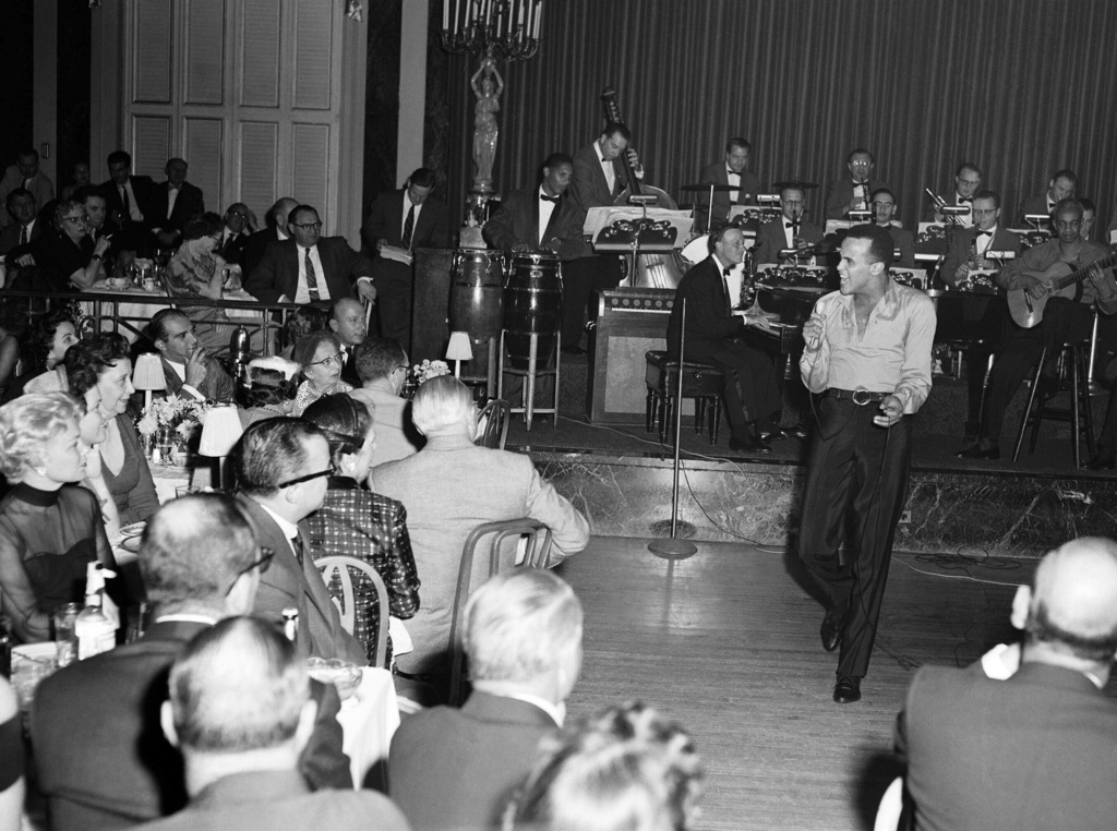 FILE - Singer Harry Belafonte appears on Oct. 2, 1956 during a performance at Waldorf-Astoria Hotel in New York.  Belafonte died Tuesday of congestive heart failure at his New York home. He was 96. (AP Photo/Al Lambert, File)