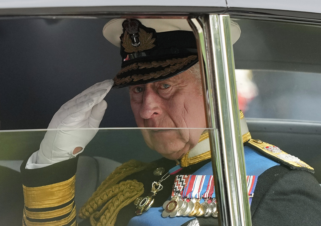 FILE  - King Charles III salutes as he leaves Westminster Abbey following the state funeral service of Queen Elizabeth II in Westminster Abbey in central London, England, Monday Sept. 19, 2022.After waiting 74 years to become king, Charles has used his first six months on the throne to meet faith leaders across the country, reshuffle royal residences and stage his first overseas state visit. With the coronation just weeks away, Charles and the Buckingham Palace machine are working at top speed to show the new king at work. (AP Photo/Martin Meissner, File)