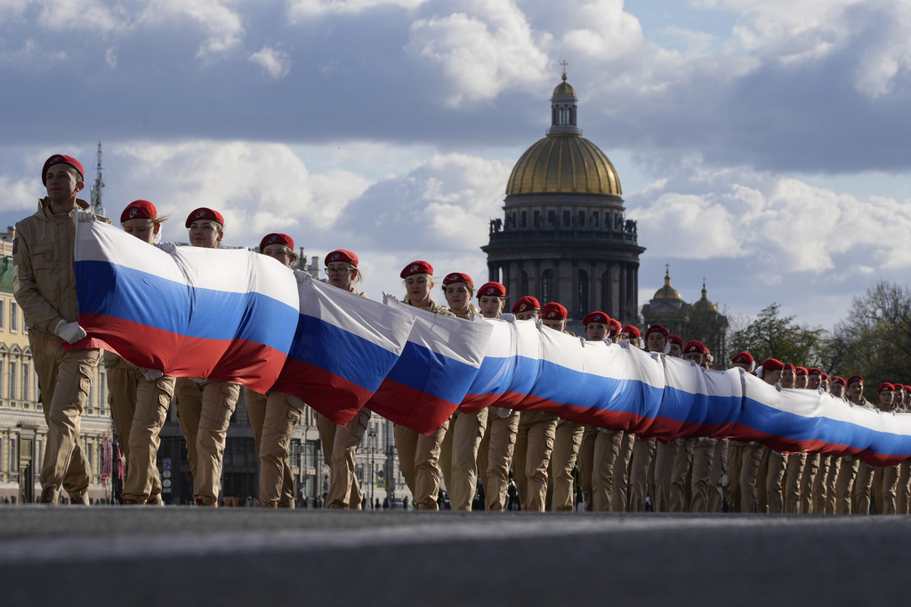 Members of Yunarmia (Young Army), an organization sponsored by the Russian military that aims to encourage patriotism among the Russian youth carry a giant ribbon in colours of Russian flag during a rehearsal for the Victory Day military parade which will take place at Dvortsovaya (Palace) Square on May 9 to celebrate 78 years after the victory in World War II in St. Petersburg, Russia, Thursday, May 4, 2023. (AP Photo/Dmitri Lovetsky)