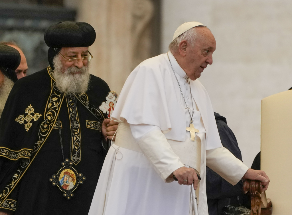Pope Francis, right, arrives for his weekly general audience in St. Peter's Square at The Vatican, with the leader of the Coptic Orthodox Church of Alexandria, Tawadros II,Wednesday, May 10, 2023. (AP Photo/Alessandra Tarantino)