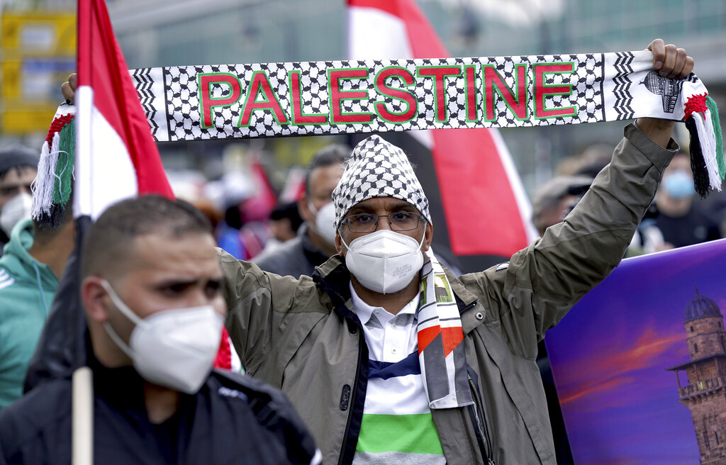 Protesters attend a protest rally in solidarity with Palestinians in Berlin, Germany, Saturday, May 15, 2021. People gather to mark 'Nakba Day' the anniversary of the displacement of hundreds of thousands of refugees from what is now Israel during the 1948 war surrounding its creation. (AP Photo/Michael Sohn)