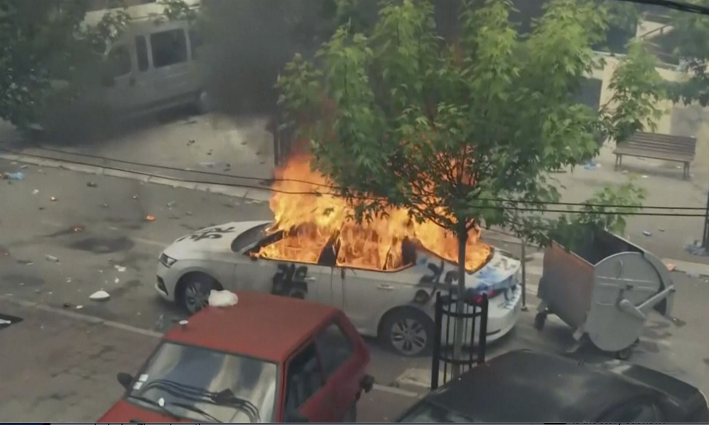 In this grab taken from video, a view of a car set on fire as KFOR soldiers clash with Kosovo Serbs in the town of Zvecan, northern Kosovo, Monday, May 29, 2023. Ethnic Serbs in northern Kosovo have clashed with troops from the NATO-led KFOR peacekeeping force outside a municipal building. They were trying to take over one of the local government offices where ethnic Albanian mayors entered last week with the help of the authorities. (AP Photo)