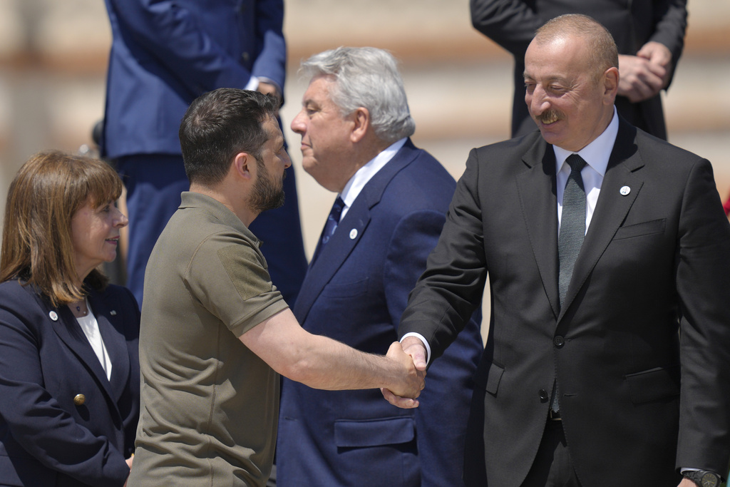 Ukraine's President Volodymyr Zelenskyy, second left, shakes hands with Azerbaijan's President Ilham Aliyev at a group photo during the European Political Community Summit at the Mimi Castle in Bulboaca, Moldova, Thursday, June 1, 2023. Leaders are meeting in Moldova Thursday for a summit aiming to show a united front in the face of Russia's war in Ukraine and underscore support for the Eastern European country's ambitions to draw closer to the West and keep Moscow at bay. (AP Photo/Vadim Ghirda)
