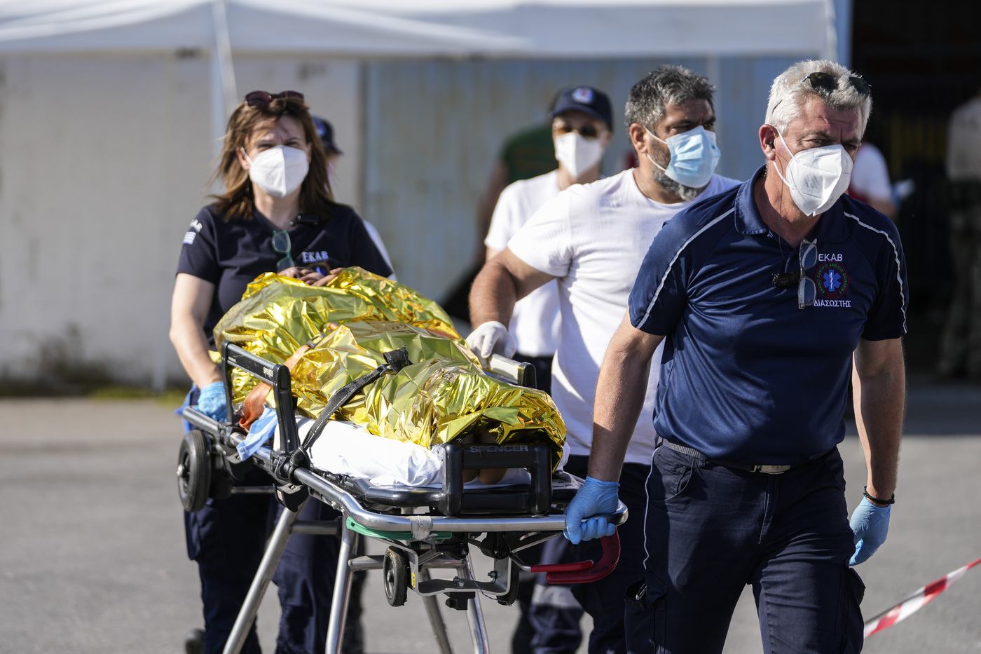 Paramedics carry an injured survivor of a shipwreck to an ambulance at the port in Kalamata town, about 240 kilometers (150miles) southwest of Athens on Wednesday, June 14, 2023. A fishing boat carrying migrants trying to reach Europe capsized and sank off Greece on Wednesday, authorities said, leaving at least 79 dead and many more missing in one of the worst disasters of its kind this year. (AP Photos/Thanassis Stavrakis)