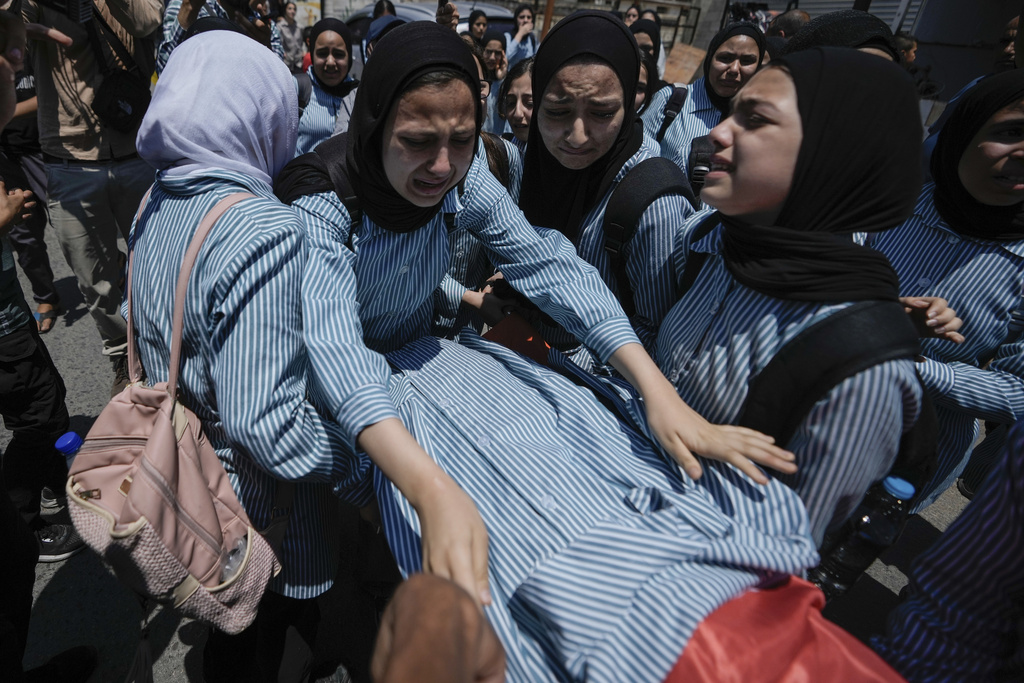 FILE - The classmates of 15-year-old Sadeel Naghniyeh carry her body during her funeral in the West Bank Jenin refugee camp Wednesday, June 21, 2023. The death of a 15-year-old girl who was killed by suspected Israeli fire during an Israeli military raid on June 19, is renewing scrutiny of Israel's record of causing civilian deaths during a more than yearlong crackdown on militants in the occupied West Bank. (AP Photo/Majdi Mohammed, File)