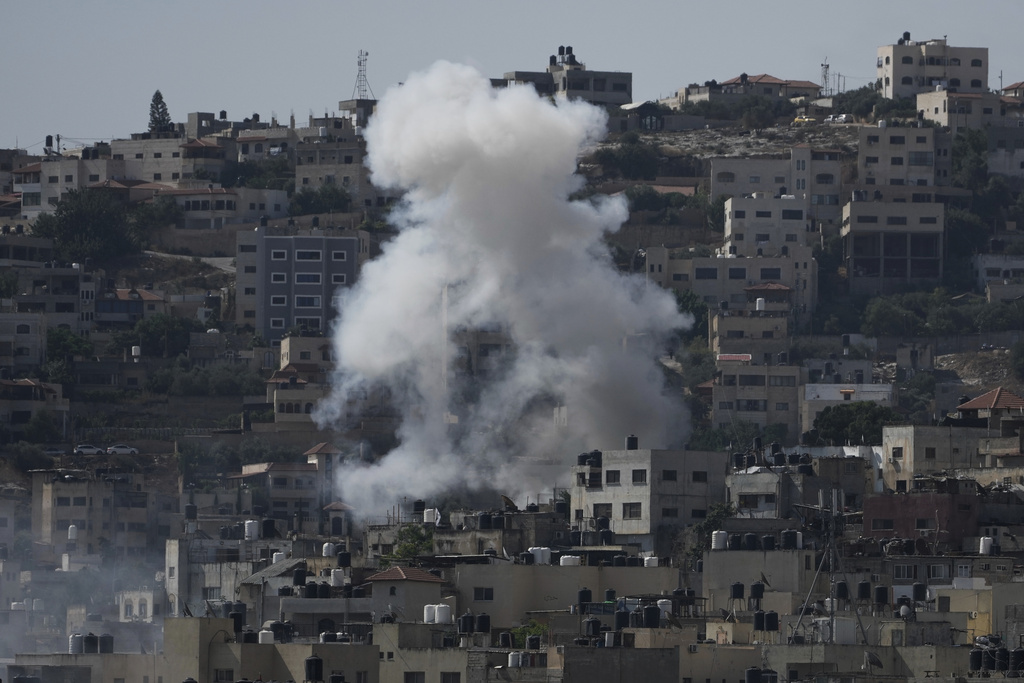 Smoke rises during an Israeli military raid of the militant stronghold of Jenin in the occupied West Bank, Monday, July 3, 2023. Palestinian health officials say at least three Palestinians were killed in the raid. (AP Photo/Majdi Mohammed)