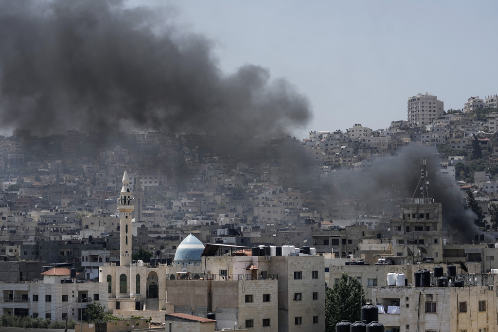 Smoke rises during an Israeli military raid of the militant stronghold of Jenin in the occupied West Bank, Monday, July 3, 2023. Israeli drones struck targets in a militant stronghold in the occupied West Bank early Monday and hundreds of troops were deployed in the area. Palestinian health officials said at least seven Palestinians were killed. (AP Photo/Majdi Mohammed)