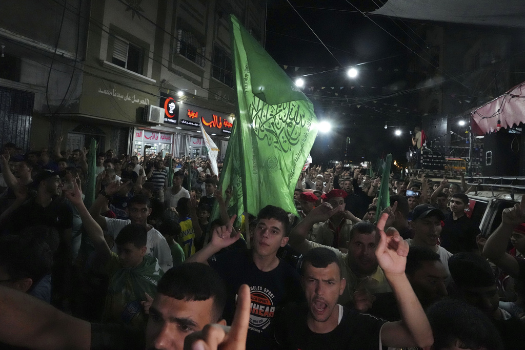 Hamas supporters wave green Islamic flags while raise their hands up and chant slogans during a protest against an Israeli military raid in the West Bank city of Jenin, at the main road of Jebaliya refugee camp, northern Gaza Strip, Monday, July 3, 2023. Israel struck targets in a militant stronghold in the occupied West Bank with drones early Monday and deployed hundreds of troops in the area. Palestinian health officials said at least eight Palestinians were killed. (AP Photo/Adel Hana)