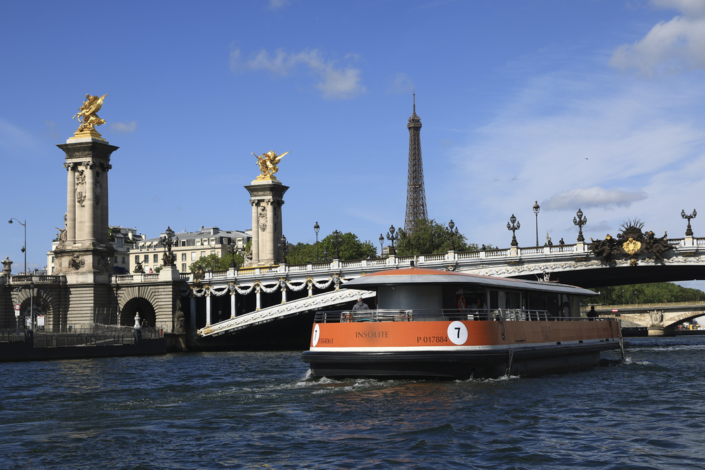 A barges cruises on the Seine river by the Alexandre III bridge during a test for the Paris 2024 Olympic Games opening ceremony, Monday, July 17, 2023 in Paris. Thousands of Olympic athletes on boats will cruise along the River Seine for the Paris 2024 Olympic Games on July 26, 2024.(AP Photo/Aurelien Morissard)